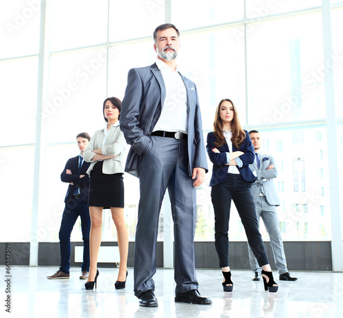 Photo: professional business team looking confidently at camera professional business team looking confidently at camera