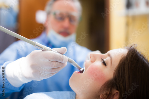 Photo: Dentist curing a female patient Dentist curing a female patient