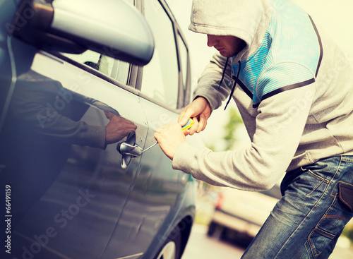 Photo: thief breaking the car lock thief breaking the car lock