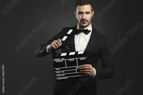 Photo: Man holding a clapboard Man holding a clapboard
