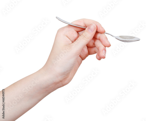 Photo: empty teaspoon in hand isolated on white empty teaspoon in hand isolated on white