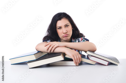 Photo: Tired student with textbooks on white Tired student with textbooks on white