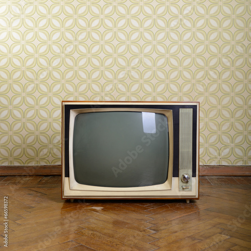Photo: retro tv with wooden case in room with vintage wallper and parqu retro tv with wooden case in room with vintage wallper and parqu