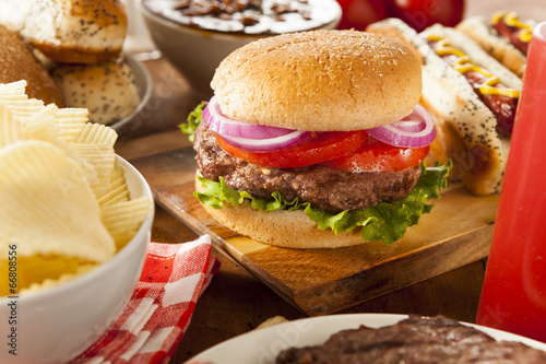 Photo: Hearty Grilled Hamburger with Lettuce and Tomato Hearty Grilled Hamburger with Lettuce and Tomato