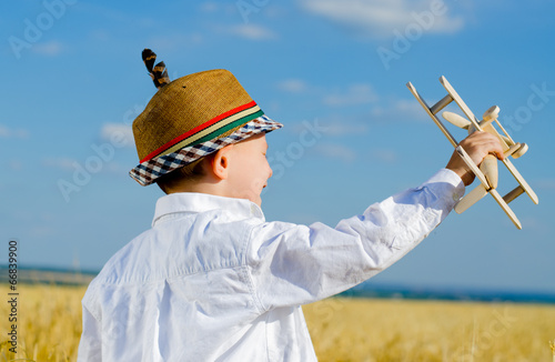 Photo: Young boy playing with a model airplane Young boy playing with a model airplane