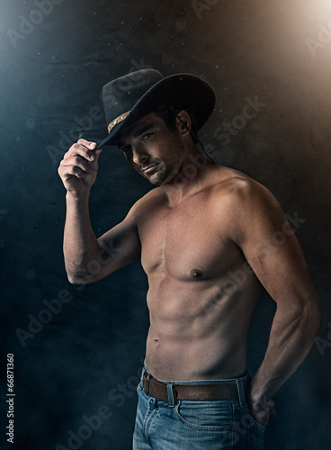 Photo: Sexy cowboy with smoky background Sexy cowboy with smoky background