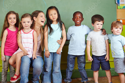 Photo: Nursery teacher with children in kindergarten Nursery teacher with children in kindergarten