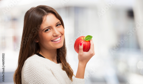 Photo: Woman holding an apple Woman holding an apple