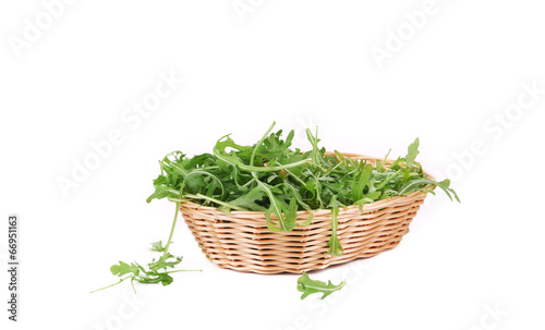 Photo: Bunch of arugula in basket. Bunch of arugula in basket.
