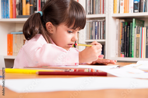 Photo: Girl doing home work Girl doing home work