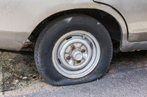 Photo: Flat rear tire on car Flat rear tire on car