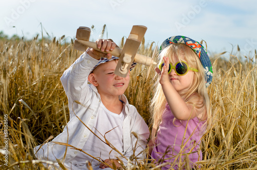 Photo: Two young children playing with a model plane Two young children playing with a model plane