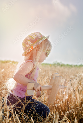 Photo: Cute little girl in a colorful hat and sunglasses Cute little girl in a colorful hat and sunglasses