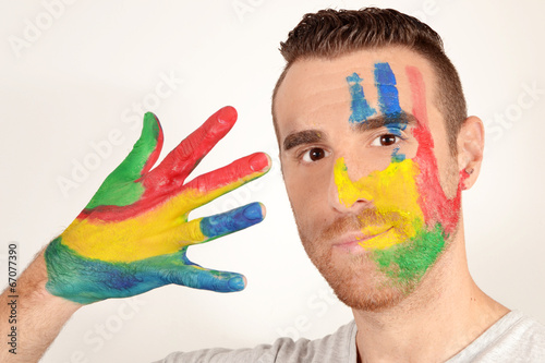 Photo: Young man with hand and face painted Young man with hand and face painted