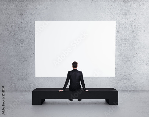Photo: businessman looking to poster businessman looking to poster