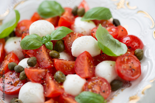 Photo: Caprese salad with capers, studio shot, close-up Caprese salad with capers, studio shot, close-up