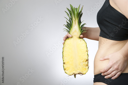 Photo: Young woman's body with pineapple Young woman's body with pineapple
