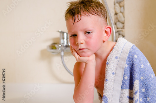 Photo: Thoughtful glum little boy draped in a towel Thoughtful glum little boy draped in a towel