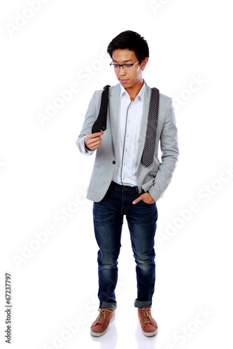 Photo: Asian man trying to choose a tie over white background Asian man trying to choose a tie over white background