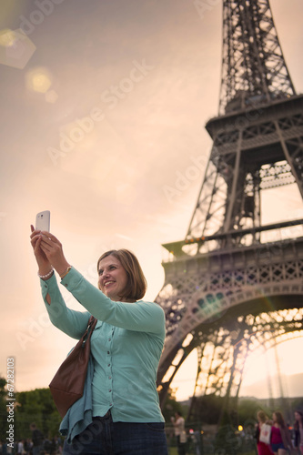 Photo: mature woman taking a selfie with the eiffel tower paris mature woman taking a selfie with the eiffel tower paris