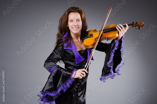 Photo: Woman artist with violin in music concept Woman artist with violin in music concept