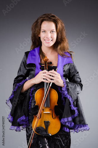 Photo: Woman artist with violin in music concept Woman artist with violin in music concept