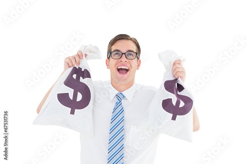 Photo: Geeky happy businessman holding bags of money Geeky happy businessman holding bags of money