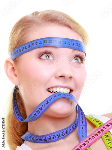 Photo: Obsessed girl with violet measure tapes around her head Obsessed girl with violet measure tapes around her head
