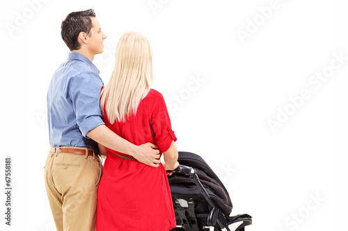 Photo: Young parents pushing a baby stroller Young parents pushing a baby stroller