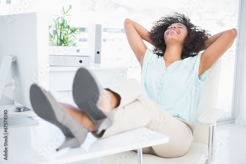 Photo: Happy businesswoman sitting with her feet up Happy businesswoman sitting with her feet up
