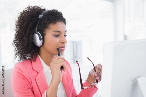 Photo: Casual graphic designer working at her desk Casual graphic designer working at her desk
