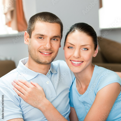 Photo: Young happy smiling attractive couple at home Young happy smiling attractive couple at home