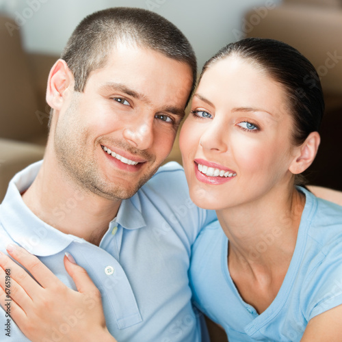 Photo: Young happy smiling attractive couple at home Young happy smiling attractive couple at home