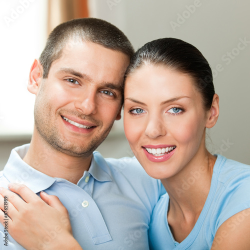Photo: Young happy smiling attractive couple at home Young happy smiling attractive couple at home