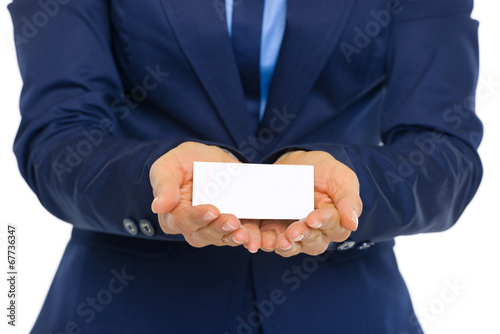 Photo: Closeup on business woman showing business card Closeup on business woman showing business card