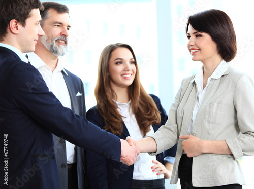 Photo: Business people shaking hands, finishing up a meeting Business people shaking hands, finishing up a meeting