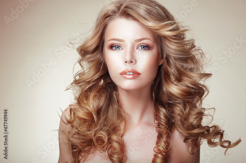 Fototapeta Portrait of Woman with Beautiful Flowing Bronzed Frizzy Hair