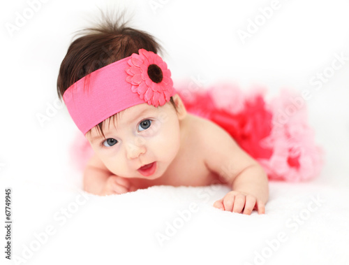 Photo: Cute little baby girl wearing a tutu and flower in her hair Cute little baby girl wearing a tutu and flower in her hair