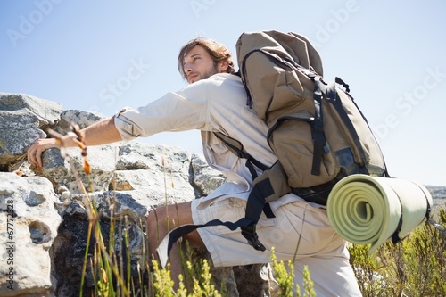 Photo: Handsome hiker hiking through rough terrain Handsome hiker hiking through rough terrain