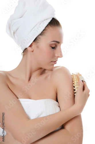 Photo: The beautiful woman with a massage brush. SPA concept. The beautiful woman with a massage brush. SPA concept.