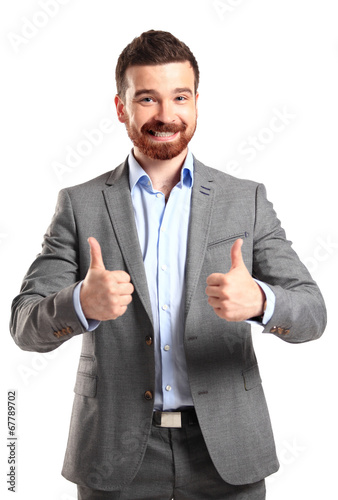 Photo: Happy smiling young business man with thumbs up gesture Happy smiling young business man with thumbs up gesture