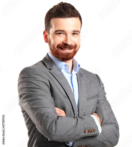 Photo: Casual young man looking at camera with arms crossed Casual young man looking at camera with arms crossed