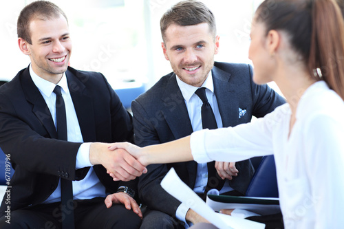 Photo: Business people shaking hands, finishing up a meeting Business people shaking hands, finishing up a meeting