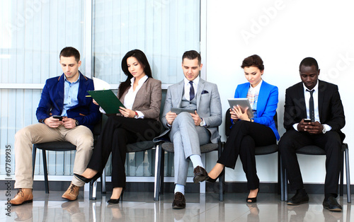 Photo: Business people waiting for job interview Business people waiting for job interview