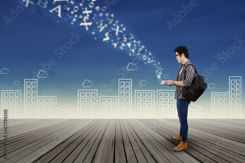 Photo: Male student and flying alphabet Male student and flying alphabet