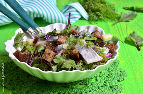Photo: Salad with herrings,bread and beet tops. Salad with herrings,bread and beet tops.