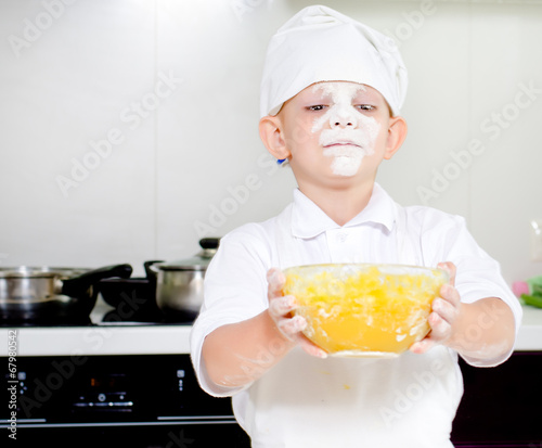 Photo: Proud little boy chef with a face full of flour Proud little boy chef with a face full of flour