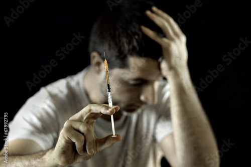 Photo: drug addict man and heroin or cocaine syringe addiction concept drug addict man and heroin or cocaine syringe addiction concept