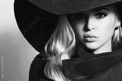 Photo: Monochrome portrait of Beautiful Blond Woman in Black Hat Monochrome portrait of Beautiful Blond Woman in Black Hat