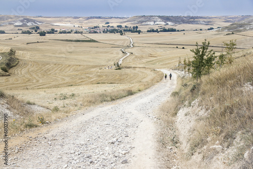 Photo: pilgrims walking a country road pilgrims walking a country road